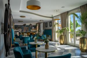 a restaurant with blue chairs and tables at Grand Hotel Alassio Beach & Spa Resort - The Leading Hotels of the World in Alassio