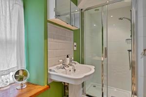 a bathroom with a sink and a shower at Finest Retreats - Meadowsweet Cottage in Wingfield +19 photos