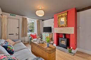 a living room with a couch and a fireplace at Finest Retreats - Meadowsweet Cottage in Wingfield