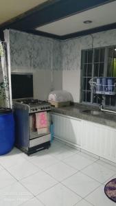 a kitchen with an oven in the middle of a kitchen at Ingeritch Cabin Transient and Homestay in Baguio