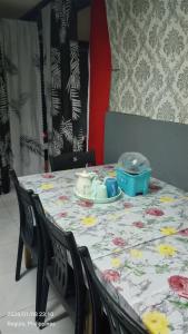 a table with a table cloth on it with a tableablish at Ingeritch Cabin Transient and Homestay in Baguio +13 photos