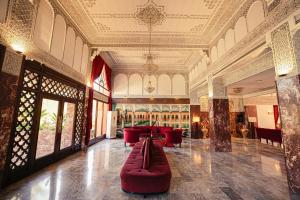 a lobby with a red couch in the middle of a building at El Andalous Lounge & Spa Hotel in Marrakesh +71 photos