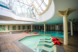a large swimming pool in a building with a skylight at Grand Hotel Alassio Beach & Spa Resort - The Leading Hotels of the World in Alassio