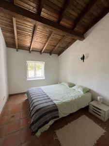 a bedroom with a bed and a window at Monte do Vale in Casa Branca +7 photos