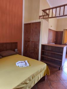 a bedroom with a bed and a wooden dresser at Maio Sweet Tartaruga in Vila do Porto