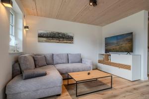 a living room with a couch and a coffee table at Doppelhaushälfte Strandgut 4 in Sylt