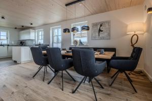 a kitchen and dining room with a table and chairs at Doppelhaushälfte Strandgut 4 in Sylt