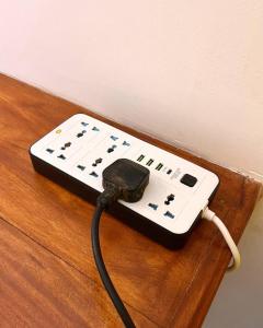 a video game controller hooked up to a wall at Polelanka guest house in Mirissa