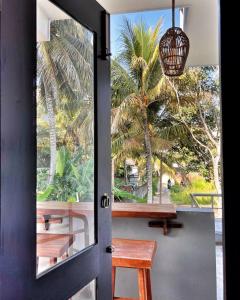 a door leading to a porch with a table and benches at Polelanka guest house in Mirissa