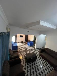 a living room with couches and chairs and a table at Funkytee Apartments in Isasi