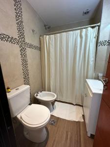 a bathroom with a toilet and a sink and a shower at Dpto 15 - Colon - 2 DORMITORIOS - PQ ALQUILERES TEMPORARIOS in Colón +12 photos