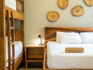 a bedroom with two beds and a wooden headboard at Casaola Mizata in Santa María Mizata +85 photos