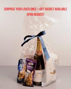 a bottle of champagne and a bag of snacks at Rummu Holiday Home in Rummu