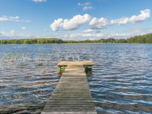 a dock in the middle of a large lake at Holiday Home Tallukka by Interhome in Pertunmaa +17 photos