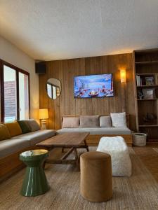 a living room with a couch and a table at Le Grand Tetras in Saint-Véran