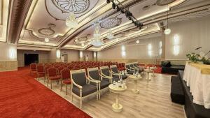 a conference room with chairs and a table and a stage at Demir Hotel in Diyarbakır