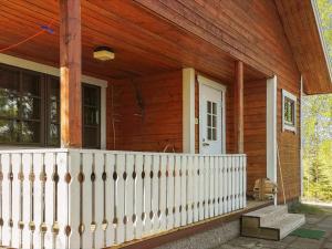 a porch of a house with a white fence at Holiday Home Aamunsarastus by Interhome in Savonranta