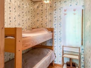 a bedroom with two bunk beds and a window at Holiday Home Leppäranta by Interhome in Harjula