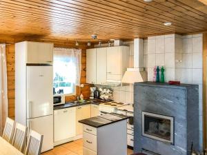 a kitchen with a white refrigerator and a stove at Holiday Home Inkeri by Interhome in Holiseva