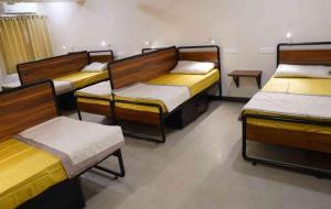 a group of beds in a room at Sukhnidras Dormitory in Hyderabad
