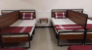 two bunk beds in a room with a table at Sukhnidras Dormitory in Hyderabad