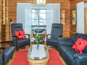 a living room with a couch and chairs and a table at Holiday Home 6309 by Interhome in Konginkangas