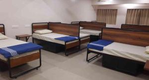 a group of four beds in a room at Sukhnidras Dormitory in Hyderabad