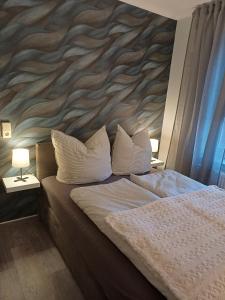 a bedroom with a large bed with a large wall at FeWo Sasa in Blankenburg +5 photos