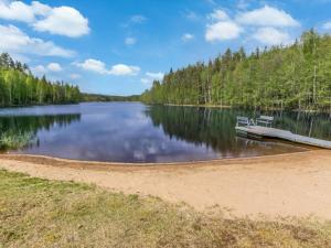 a bench sitting on a dock on a lake at Holiday Home 7734 by Interhome in Kaartilankoski