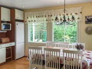a dining room with a table with chairs and a window at Holiday Home Merivanamo by Interhome in Haukipudas