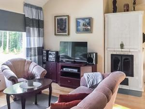 a living room with a couch and a tv at Holiday Home Merivanamo by Interhome in Haukipudas +11 photos
