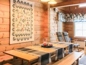a dining room with a table and two chairs at Holiday Home Varvali by Interhome in Lahdenkylä +17 photos