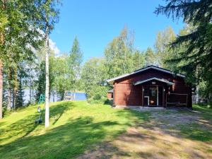 a log cabin in the middle of a field at Holiday Home Saarenpää by Interhome in Koivisto