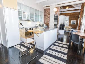 a kitchen with white cabinets and a table and chairs at Holiday Home Säikkäranta by Interhome in Oulunsalo