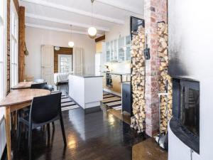 a kitchen and living room with a fireplace and a table and chairs at Holiday Home Säikkäranta by Interhome in Oulunsalo