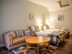 a room with two beds and a couch and a table at Orchard House - Dingle Town Centre in Dingle
