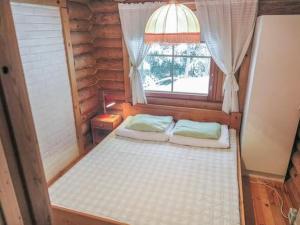 a small room with a bed and a window at Holiday Home Hepolehto by Interhome in Säkinmäki