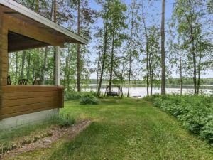 a porch of a house with a view of a lake at Holiday Home Kuusiranta by Interhome in Harjula