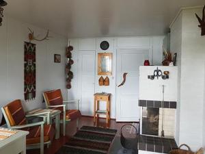 a room with a living room with a fireplace at Holiday Home Simola by Interhome in Nimimäki