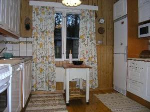 a kitchen with a table and a window at Holiday Home Simola by Interhome in Nimimäki