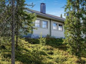 a white house with trees in front of it at Holiday Home Lupposyöte b1 by Interhome in Syöte