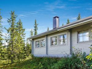 a house with a chimney on top of it at Holiday Home Lupposyöte b1 by Interhome in Syöte