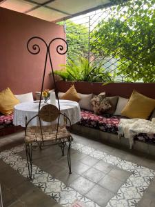a room with a table and a couch and a table at Lovely flat in nice garden in Rabat