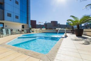 a swimming pool on the roof of a building at Alven Hotel by Slaviero Hotéis in Joinville +93 photos