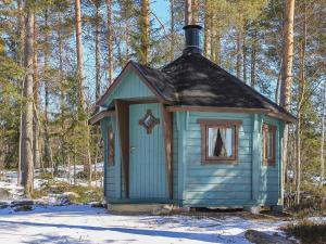 a blue house with a black roof in the snow at Holiday Home Marjaranta by Interhome in Konnevesi +13 photos