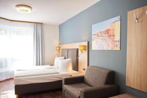 Postel nebo postele na pokoji v ubytování BlnCty Hotel