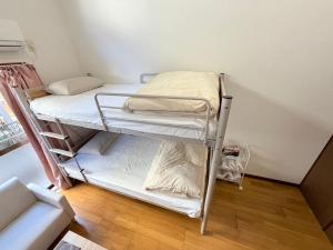 a small room with a bunk bed in a room at ハイツロフト102 in Nagasaki +6 photos