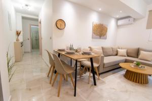 a living room with a table and a couch at Amelia Summer Homes in Pérdika +9 photos