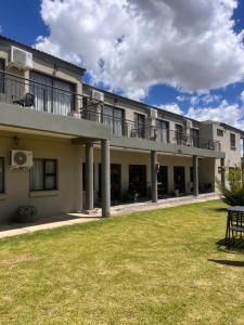 an apartment building with a lawn in front of it at The Anne Guest House in Maseru