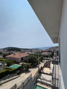 a view from a balcony of a building with a pool at Maia Suites in Çeşme